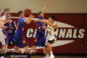 William Storie (#45) of the LaCrosse Leopards passes the ball to a teammate against the Ellinwood Eagles at the 2012 Hoisington Winter Jam Basketball Tournament.