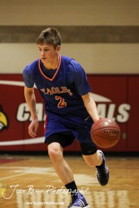 Patrick Ringering (#2) of the Ellinwood Eagles drives down the court with the basketball against the LaCrosse Leopards at the 2012 Hoisington Winter Jam Basketball Tournament.