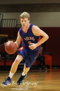 Kale Clawson (#3) of the Ellinwood Eagles takes the basketball down the court against the LaCrosse Leopards at the 2012 Hoisington Winter Jam Basketball Tournament.