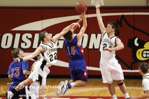 LaCrosse Leopards Tayler Stull (#22) and Kip Keeley (#24) try to block the shot of Ellinwood Eagle Kyle Blakeslee (#15) at the 2012 Hoisington Winter Jam Basketball Tournament.