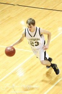 Austin Webs (#23) of the LaCrosse Leopards drives down the court with the basketball against the Ellinwood Eagles at the 2012 Hoisington Winter Jam Basketball Tournament.