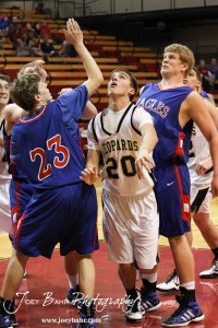 Ellinwood Eagles Cody Isern (#23) and Ian Goering (#50) react to a shot by LaCrosse Leopard Marshall Jay (#20) at the 2012 Hoisington Winter Jam Basketball Tournament.
