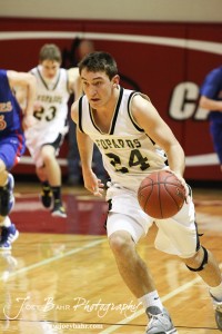 Kip Keeley (#24) of the LaCrosse Leopards drives down the court with the basketball against the Ellinwood Eagles at the 2012 Hoisington Winter Jam Basketball Tournament.
