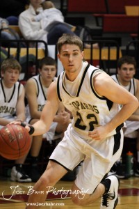 Tayler Stull (#22) of the LaCrosse Leopards drives towards the Ellinwood Eagles defense at the 2012 Hoisington Winter Jam Basketball Tournament.