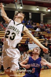 Austin Webs (#23) of the LaCrosse Leopards finishes off a layup against the Ellinwood Eagles at the 2012 Hoisington Winter Jam Basketball Tournament.