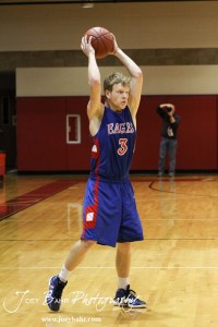 Kale Clawson (#3) of the Ellinwood Eagles passes the ball to a teammate against the LaCrosse Leopards at the 2012 Hoisington Winter Jam Basketball Tournament.