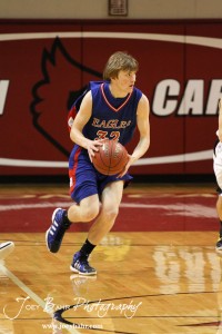 Tanner Swank (#32) of the Ellinwood Eagles prepares to pass the ball against the LaCrosse Leopards at the 2012 Hoisington Winter Jam Basketball Tournament.