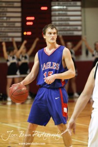 Ellinwood Eagle Kyle Blakeslee (#15) looks for a teammate to pass the basketball to against the LaCrosse Leopards at the 2012 Hoisington Winter Jam Basketball Tournament.