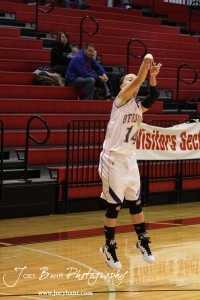 Dekota Nelson (#14) of the Otis-Bison Lady Cougars takes a shot against the Ellinwood Lady Eagles at the 2012 Hoisington Winter Jam Basketball Tournament.