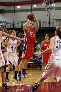 Lindsey Zink (#24) of the Ellinwood Lady Eagles takes a shot against the defense of the Otis-Bison Lady Cougars at the 2012 Hoisington Winter Jam Basketball Tournament.