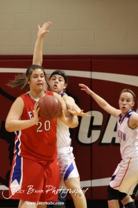 Ellinwood Lady Eagle Kelsea Ward (#20) passes the ball out to Jenna Snell (#5) against the Otis-Bison Lady Cougars at the 2012 Hoisington Winter Jam Basketball Tournament.