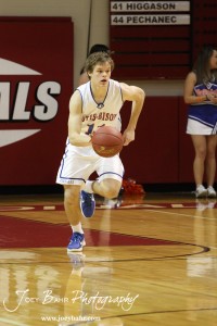 Otis-Bison Cougar Dylan Wissman (#11) drives the ball down the court against the LaCrosse Leopards at the 2012 Hoisington Winter Jam Basketball Tournament.