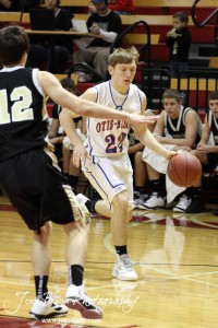 Otis-Bison Cougar Patrick Piper (#22) drives towards the LaCrosse Leopards defense at the 2012 Hoisington Winter Jam Basketball Tournament.