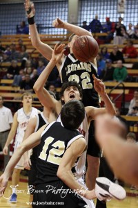 Otis-Bison Cougar Brandon Pechanec (#44) goes up while being defended by LaCrosse Leopards Clayton Basgall (#12) and Tayler Stull (#22) at the 2012 Hoisington Winter Jam Basketball Tournament.