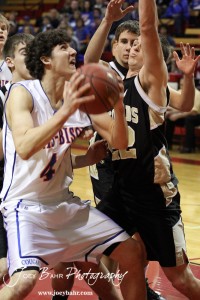 Otis-Bison Cougar Brandon Pechanec (#44) goes up for a shot while being defended by Tayler Stull (#22) of the LaCrosse Leopards at the 2012 Hoisington Winter Jam Basketball Tournament.