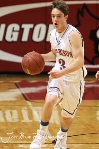 Trevor Keller (#3) of the Otis-Bison Cougars drives the ball down the court against the LaCrosse Leopards at the 2012 Hoisington Winter Jam Basketball Tournament.
