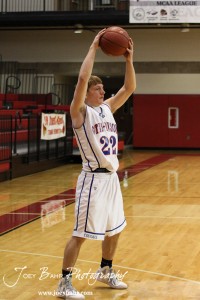 Patrick Piper (#22) of the Otis-Bison Cougars looks for a teammate to pass the ball to at the 2012 Hoisington Winter Jam Basketball Tournament.