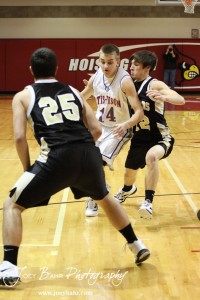 Otis-Bison Cougar Zachary Stejskal (#14) drives between two LaCrosse Leopard defenders at the 2012 Hoisington Winter Jam Basketball Tournament.