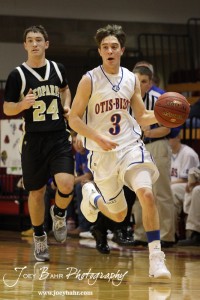 Otis-Bison Cougar Trevor Keller (#3) drives past LaCrosse Leopard Kip Keeley (#24) at the 2012 Hoisington Winter Jam Basketball Tournament.