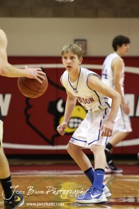 Otis-Bison Cougar Justus Bartonek (#1) watches a LaCrosse Leopard at the 2012 Hoisington Winter Jam Basketball Tournament.
