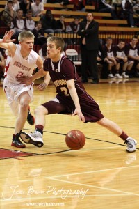 Victoria Knight Corey Dinkel (#2) drives against the defense of Hoisington Cardinal Trent Schremmer (#2) at the 2012 Hoisington Winter Jam Basketball Tournament.