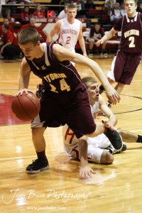 Victoria Knight Clayton Roth (#24) drives past Derrick Kaiser (#32) of the Hoisington Cardinals at the 2012 Hoisington Winter Jam Basketball Tournament.