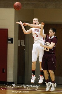 Jacob Durrett (#3) of the Hoisington Cardinals passes the ball against the Victoria Knights at the 2012 Hoisington Winter Jam Basketball Tournament.