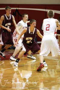 Victoria Knight Bryan Dome (#21) watches Hoisington Cardinal Trent Schremmer (#2) while on defense at the 2012 Hoisington Winter Jam Basketball Tournament.