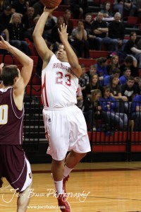 Taylor Crawford (#23) of the Hoisington Cardinals goes up for a shot against the Victoria Knights at the 2012 Hoisington Winter Jam Basketball Tournament.