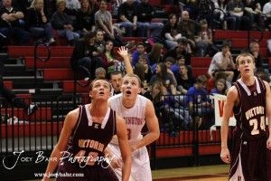 Victoria Knight Phillip Nowak (#40) and Hoisington Cardinal Jacob Durrett (#3) watch a free throw attempt at the 2012 Hoisington Winter Jam Basketball Tournament.