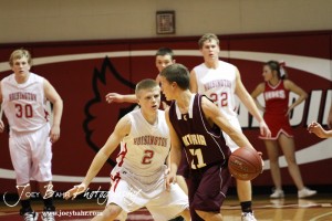 Trent Schremmer (#2) of the Hoisington Cardinals defends against Victoria Knight Bryan Dome (#21) at the 2012 Hoisington Winter Jam Basketball Tournament.