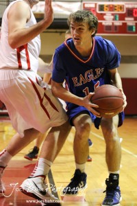 Kyle Blakeslee (#15) of the Ellinwood Eagles prepares to go up for a shot against Hoisington Cardinal Cody Stetler (#4) at the Hoisington Activities Center in Hoisington, Kansas on February 10, 2012.  Photo: Joey Bahr