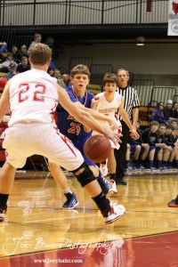 Cody Isern (#23) of the Ellinwood Eagles tries to pass the basketball past Hoisington Cardinal defender Anthony Broeder (#22) at the Hoisington Activities Center in Hoisington, Kansas on February 10, 2012.  Photo: Joey Bahr