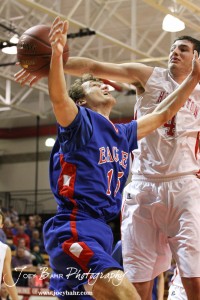 Hoisington Cardinal Cody Stetler (#4) defends against a shot by Ellinwood Eagle Kyle Blakeslee (#15) at the Hoisington Activities Center in Hoisington, Kansas on February 10, 2012.  Photo: Joey Bahr