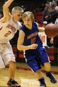 Ellinwood Eagle Gavin Vink (#5) drives past Hoisington Cardinal Trent Schremmer (#2) at the Hoisington Activities Center in Hoisington, Kansas on February 10, 2012.  Photo: Joey Bahr