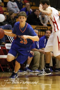 Cody Isern (#23) of the Ellinwood Eagles drives past a Hoisington Cardinal defender at the Hoisington Activities Center in Hoisington, Kansas on February 10, 2012.  Photo: Joey Bahr