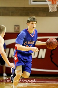 Ellinwood Eagle Cody Isern (#23) drives past a Hoisington Cardinal defender at the Hoisington Activities Center in Hoisington, Kansas on February 10, 2012.  Photo: Joey Bahr