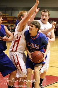 Ellinwood Eagle Cody Isern (#23) drives into Hoisington Cardinal Darin Poland (#15) at the Hoisington Activities Center in Hoisington, Kansas on February 10, 2012.  Photo: Joey Bahr