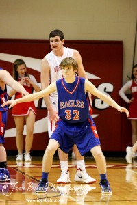 Ellinwood Eagle defender Tanner Swank (#32) tries to hide Hoisington Cardinal Cody Stetler (#4) at the Hoisington Activities Center in Hoisington, Kansas on February 10, 2012.  Photo: Joey Bahr