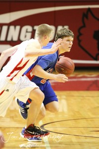 Ellinwood Eagle Cody Isern (#23) tries to drive through the defense of Hoisington Cardinal Trent Schremmer (#2) at the Hoisington Activities Center in Hoisington, Kansas on February 10, 2012.  Photo: Joey Bahr