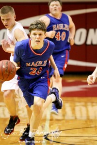 Cody Isern (#23) of the Ellinwood Eagles drives past Hoisington Cardinal defender Trent Schremmer (#2) at the Hoisington Activities Center in Hoisington, Kansas on February 10, 2012.  Photo: Joey Bahr