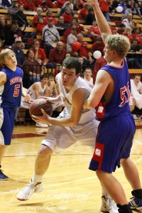 Cody Stetler (#4) of the Hoisington Cardinals looks to move against the defending of Ellinwood Eagle Ian Goering (#50) at the Hoisington Activities Center in Hoisington, Kansas on February 10, 2012.  Photo: Joey Bahr