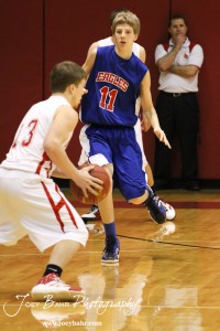 Marc Waite (#11) of the Ellinwood Eagles moves to defend against Brooks Linsner (#13) of the Hoisington Cardinals at the Hoisington Activities Center in Hoisington, Kansas on February 10, 2012.  Photo: Joey Bahr
