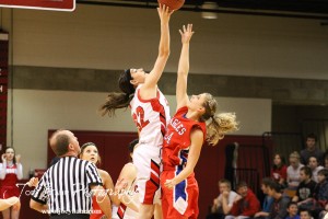 Hoisington Lady Cardinal Mallory Flagor (#32) and Ellinwood Lady Eagle Lindsey Zink (#24) go up for the tipoff at the Hoisington Activities Center in Hoisington, Kansas on February 10, 2012.  Photo: Joey Bahr