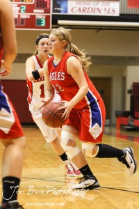 Darrien Beckwith (#12) of the Ellinwood Lady Eagles drives through the Hoisington Lady Cardinals defense at the Hoisington Activities Center in Hoisington, Kansas on February 10, 2012.  Photo: Joey Bahr