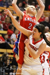 Sophie Hayes (#2) of the Ellinwood Lady Eagles drives against BreAnna Burns (#5) of the Hoisington Lady Cardinals at the Hoisington Activities Center in Hoisington, Kansas on February 10, 2012.  Photo: Joey Bahr
