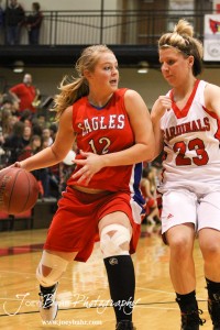Ellinwood Lady Eagle Darrien Beckwith (#12) drives against Hoisington Lady Cardinal Blakelee Cooper (#23) at the Hoisington Activities Center in Hoisington, Kansas on February 10, 2012.  Photo: Joey Bahr