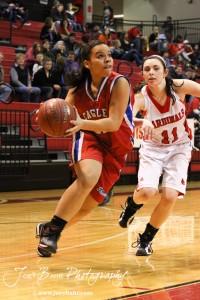 Ellinwood Lady Eagle Twany Arndt (#22) drives past Hoisington Lady Cardinal Olivia Lowry (#11) at the Hoisington Activities Center in Hoisington, Kansas on February 10, 2012.  Photo: Joey Bahr