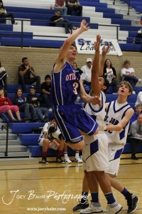 OB_Boys_vs_St_John_BB_2-21-12_0021 Trevor Keller (#3) of the Otis-Bison Cougars goes for a layup against the St. John Tigers at St. John High School in St. John, Kansas on February 21, 2012. Photo: Joey Bahr