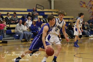 OB_Boys_vs_St_John_BB_2-21-12_0032 Dylan Wissman (#11) of the Otis-Bison Cougars drives past St. John Tiger Dean Wade (#32) at St. John High School in St. John, Kansas on February 21, 2012. Photo: Joey Bahr